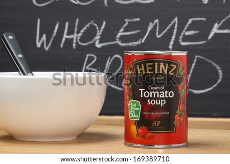 Bracknell, England - January 02, 2014: A tin of Heinz Cream of Tomato Soup next to a white bowl and in front of a blackboard. Heinz started manufacturing food products in the USA in 1869
