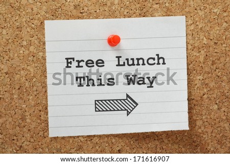 The phrase Free Lunch This Way with a direction arrow typed on a piece of paper and pinned to a cork notice board.