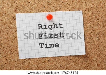 The phrase Right First Time typed on a piece of Graph Paper and pinned to a cork notice board