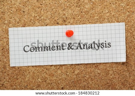 The words Comment and Analysis typed on a piece of graph paper and pinned to a cork notice board