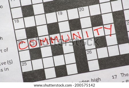 The word Community in red ink on a newspaper crossword puzzle
