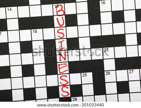 The word Business written in red ink on a newspaper crossword puzzle