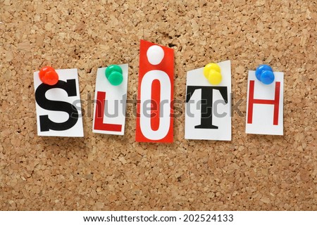 The word Sloth, one of the seven deadly sins in cut out magazine letters pinned to a cork notice board