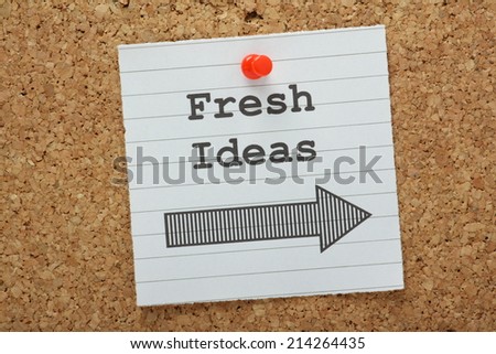 The phrase Fresh Ideas with an arrow pointing in the right direction on a cork notice board