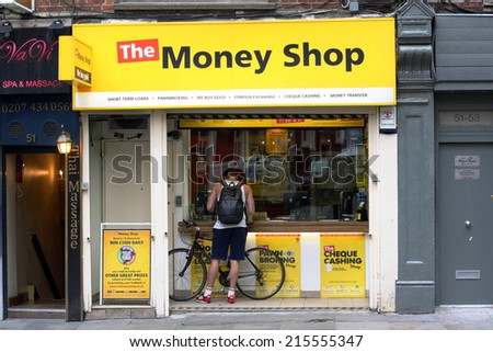 London, England - Sept 4th, 2014: A man stands at the window of The Money Shop in the Soho area of London. The Money Shop provides payday loans, pawn brokering and other financial services in the UK