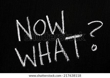 The question Now What? written by hand in white chalk on a blackboard