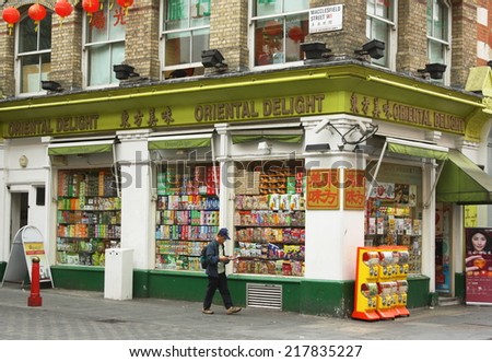 London, England - Sept 4th, 2014: A man walks by the Oriental Delight supermarket in Macclesfield Street in London\'s Chinatown District - a community of restaurants and businesses since the 1950s