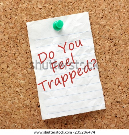 The question Do You Feel Trapped written on a piece of paper and pinned to a cork notice board. A concept for being stuck in a situation at work or in life that makes you unhappy.