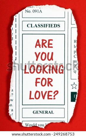 The phrase Are You Looking For Love? torn out from the classified advertising section of a newspaper
