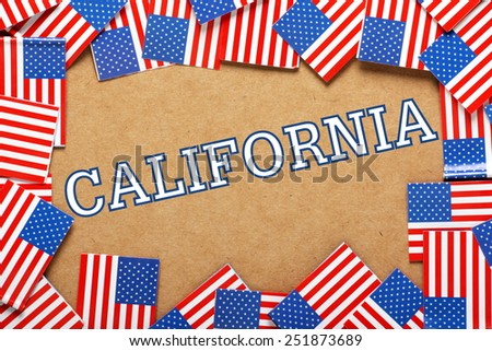 Miniature flags of the United States of America form a border on brown card around the word California