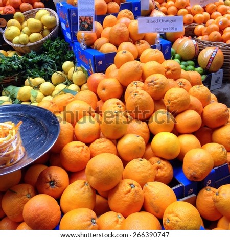 London, United Kingdom - April 02, 2015: Display of oranges and lemons for sale on a fruit stall in Borough Market, London