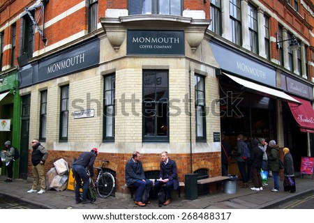 London, England - April 02, 2015: People outside and queuing to enter the Monmouth Coffee Company store near Borough Market, London. The company began roasting and retailing coffee in London in 1978