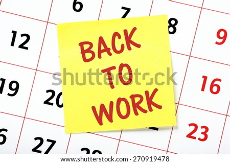 The phrase Back To Work on a yellow sticky note attached to a wall calendar as a reminder