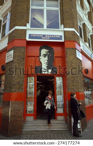 London, England - April 30, 2015: People outside the entrance of the Vintage Magazine Shop in Soho, London. The store has retailed original printed materials and ephemera to collectors since 1975