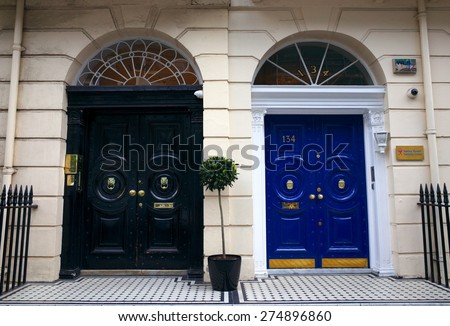 London, England - April 30, 2015: Georgian style entrances to clinics in Harley Street, London. Harley Street has a global reputation for provision of private medical and health services