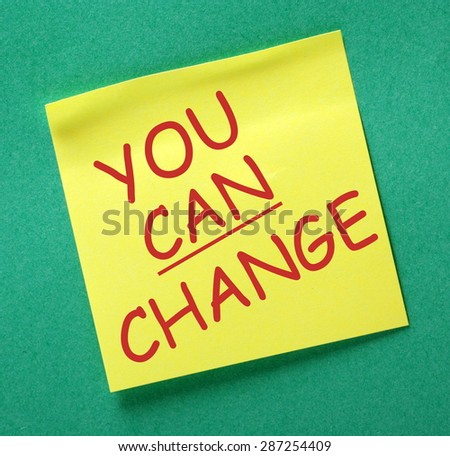 The phrase You Can Change in red text on a yellow sticky noted posted on a green notice board as a reminder
