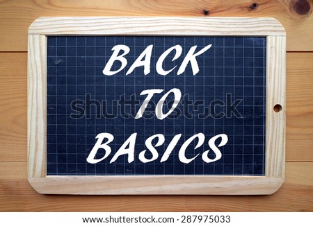 The phrase Back to Basics in white text on a slate blackboard