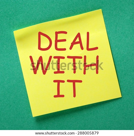 The phrase Deal With It in red text on a yellow sticky note posted on a green background