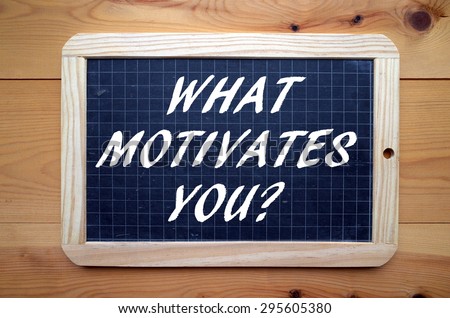 The phrase What Motivates You, a popular interview question in white text on a blackboard