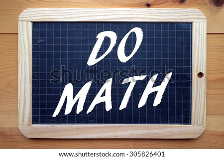 The phrase Do Math in white text on a blackboard as a reminder that Math is one of the core subjects of a rounded education