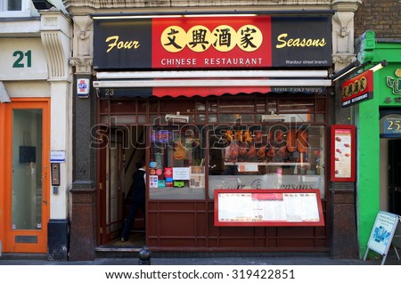 London, England - Sept 09, 2015: Person entering a Chinese Restaurant doorway in a Chinatown street in London, England. There are more than eighty restaurants in the Chinatown District.