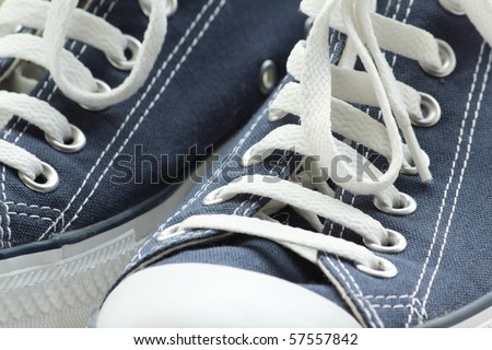 Abstract detail of a pair of blue canvas training shoes