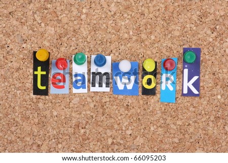 The word Teamwork in cut out magazine letters pinned to a cork notice board as a business concept
