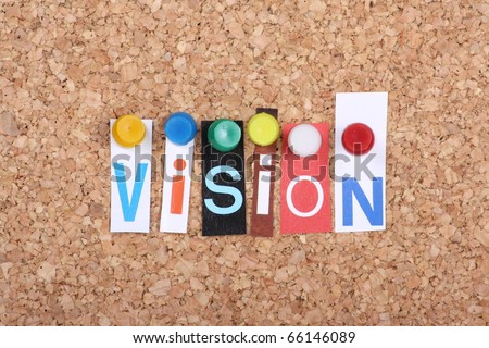 The word Vision in cut out magazine letters pinned to a cork notice board as a concept for success in business