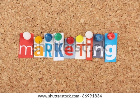 The word Marketing in cut out magazine letters pinned to a cork notice board