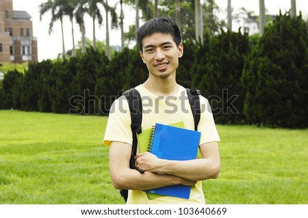 happy student on a grass at a campus at a campus