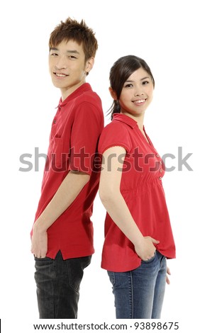 young woman and man standing back to back