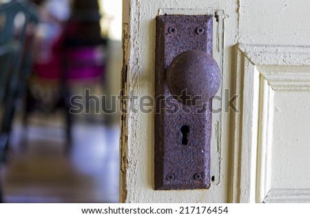 Old rusty door knob resembling face