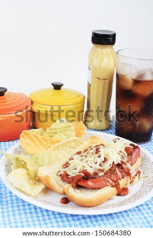 Hot dog sliced and fried on bun and covered with chili and grated Pepper Jack Cheese.  Served with veggie chips and ice cold soft drink.