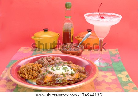 Mexican Enchilada Dinner with frozen Margarita in colorful Mexican Restaurant setting.