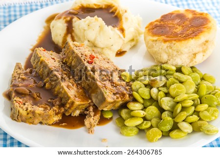 Meatloaf dinner with mashed potatoes and gravy and baby lima beans.  Blue Gingham Country Kitchen Setting.