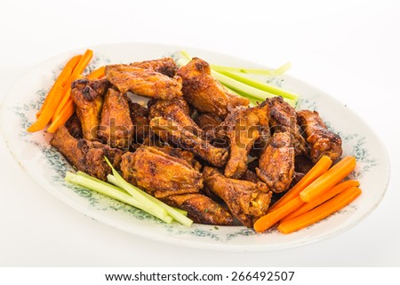 Hot and Spicy Buffalo Wing Platter on white background with copy space.  Carrot and celery sticks.