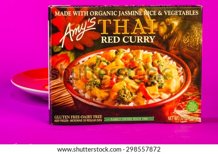 LLANO TX-JULY 20, 2015:  Frozen Amy\'s Thai Red Curry dinner with organic Jasmine Rice and Vegetables with red plate and purple background.