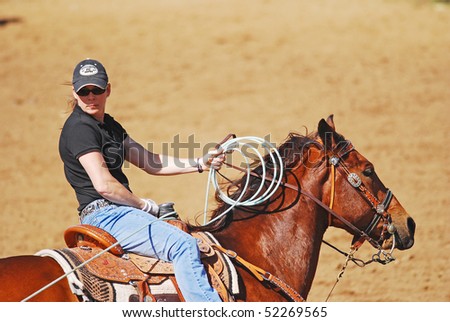 LLANO, TEXAS - APRIL 18:  Cowgirl has successfully roped the head of a calf.  Team Roping competition at the Llano Crawfish Open on April 18, 2008 in Llano, Texas.