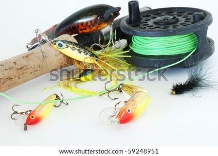 Fly Rod and Reel with assortment of fishing lures, crank baits, and black woolly bully trout fly on plain background