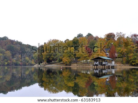 Dock on the Tennessee River, taken on an overcast day in early Autumn when on a day when the water was mirror like, reflecting the hint of fall color in the trees