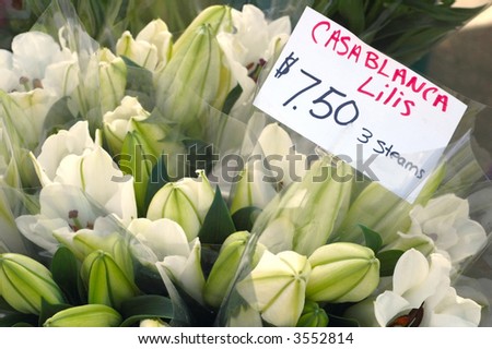 Casablanca lilies for sale in a stall at a farmer\'s market in summer -- traditional wedding flower