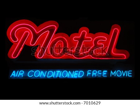 Illuminated motel neon sign with air conditioning and free movie