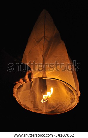 A hand holding a chinese lantern.