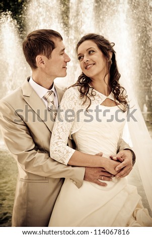 bride and groom against the fountain