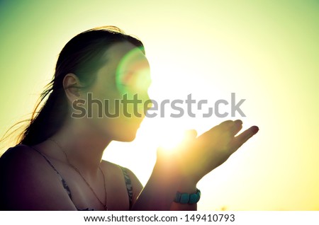 woman silhouette holding the sun