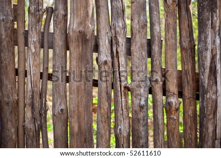 old fence with a visible behind him grass as a background