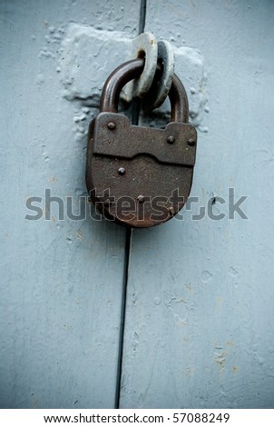old rusted lock on a blue gate