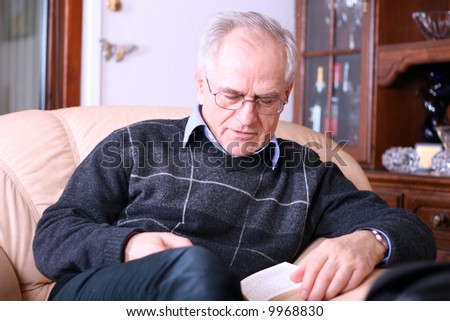 Senior man reading a book (falling asleep while reading)
