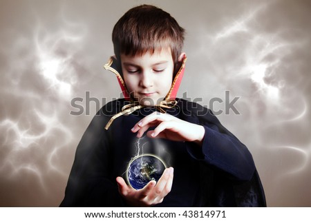 Young magician trying to save the Earth with his magic (focus on the hands/earth)