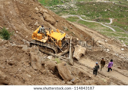 MANALI, INDIA - AUG 29 :  Border Roads Organization clear the road to Leh affected by landslide on August 29, 2012 in Manali, India. Landslides are regular phenomenon of this high altitude region.